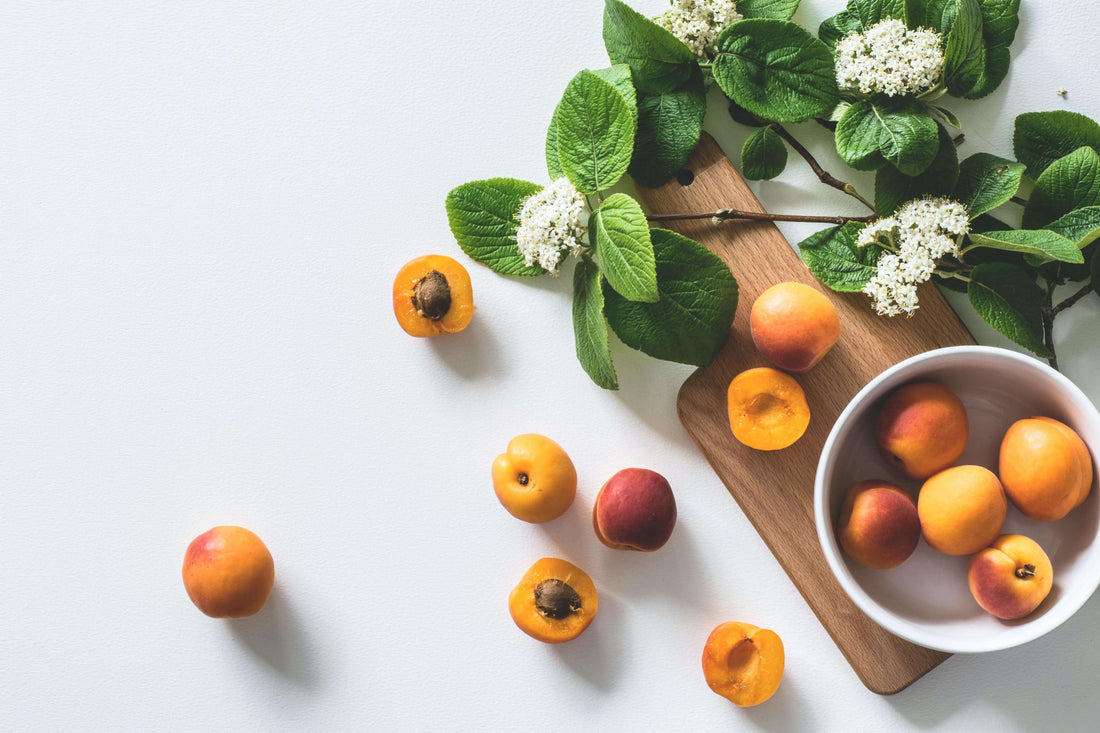 Apricots in a white bowl, illustrating the benefits of apricot kernel oil